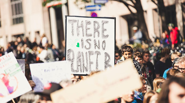 People holding signs in a crowd