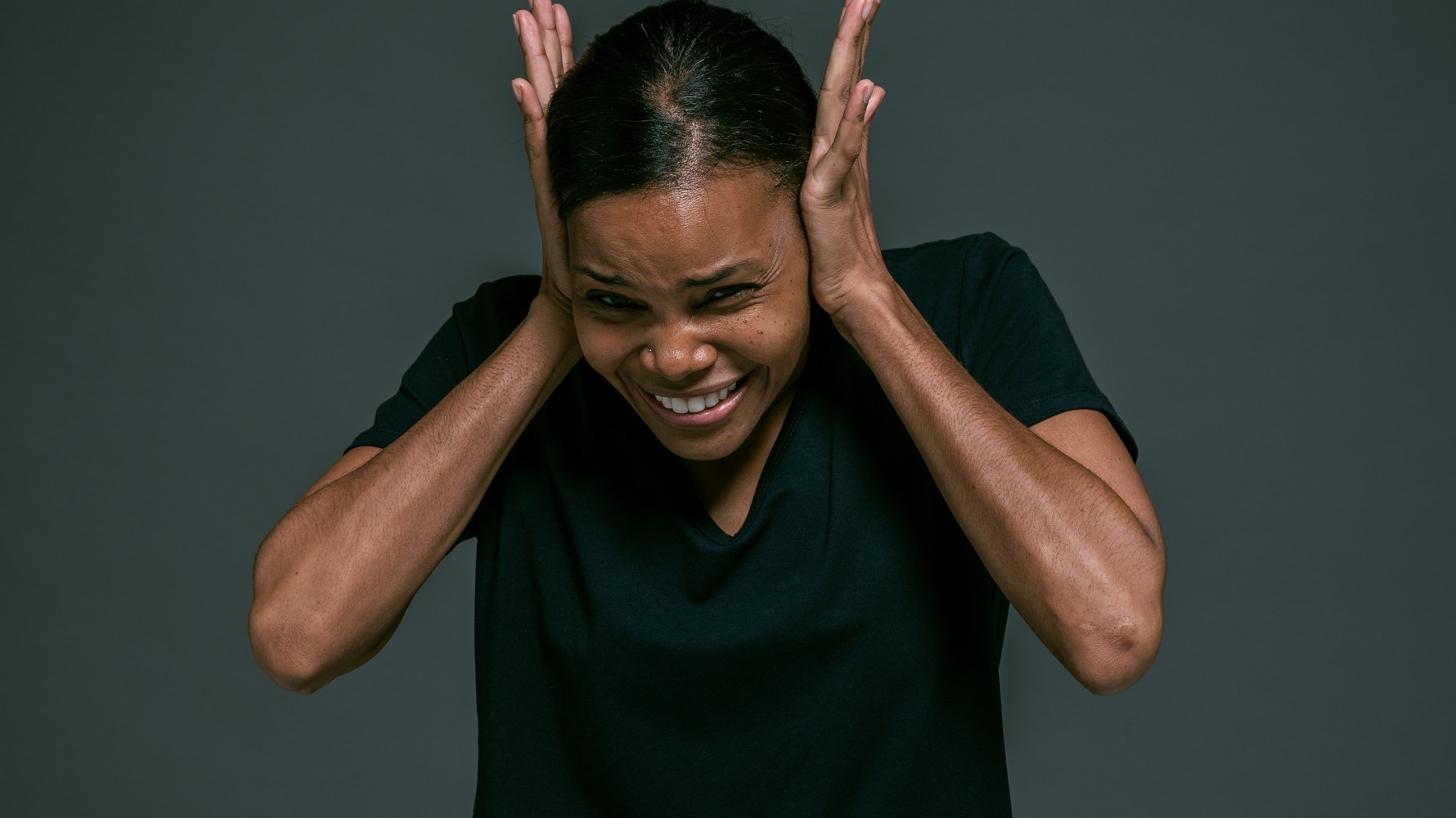 Woman covering her ears with her hands. 